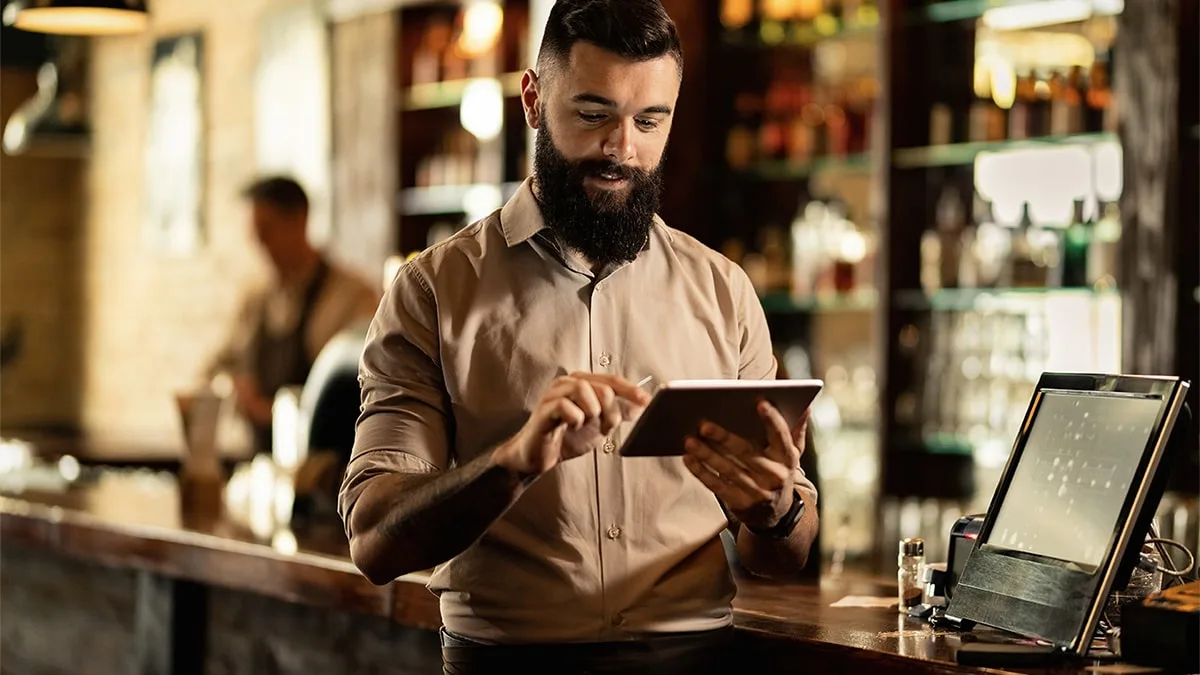 Restaurant owners checking at his POS system
