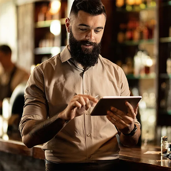 Restaurant owners checking at his POS system 