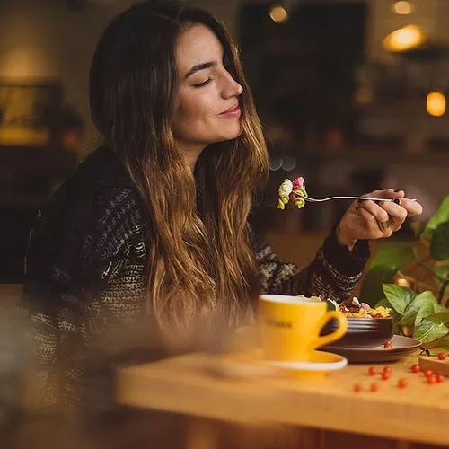 Guest enjoying her meal without stress because she made her reservation on a booking system for restaurant 