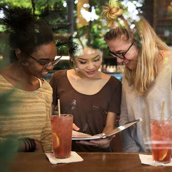 Women discussing the feedback they are going to leave to a restaurant 