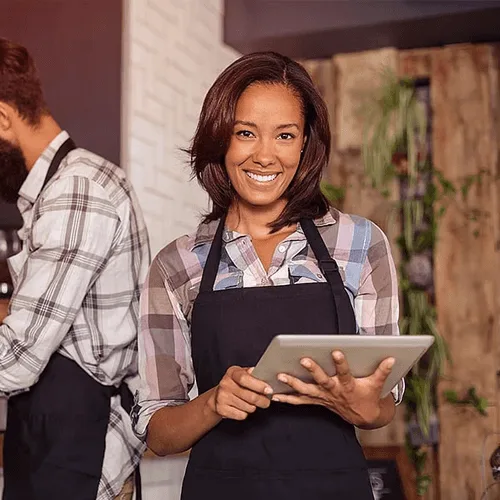 Restaurant owner smiling that they found the best technologies for their business, from POS to reservation management software